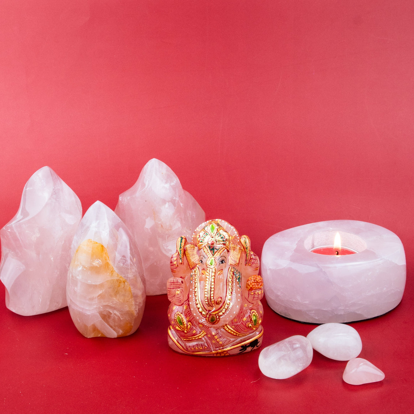 Love Remedies by Energy Muse, featuring a Rose Quartz Flame crystal, a Rose Quartz tealight candle holder, and a painted Rose Quartz Ganesha carved figurine.