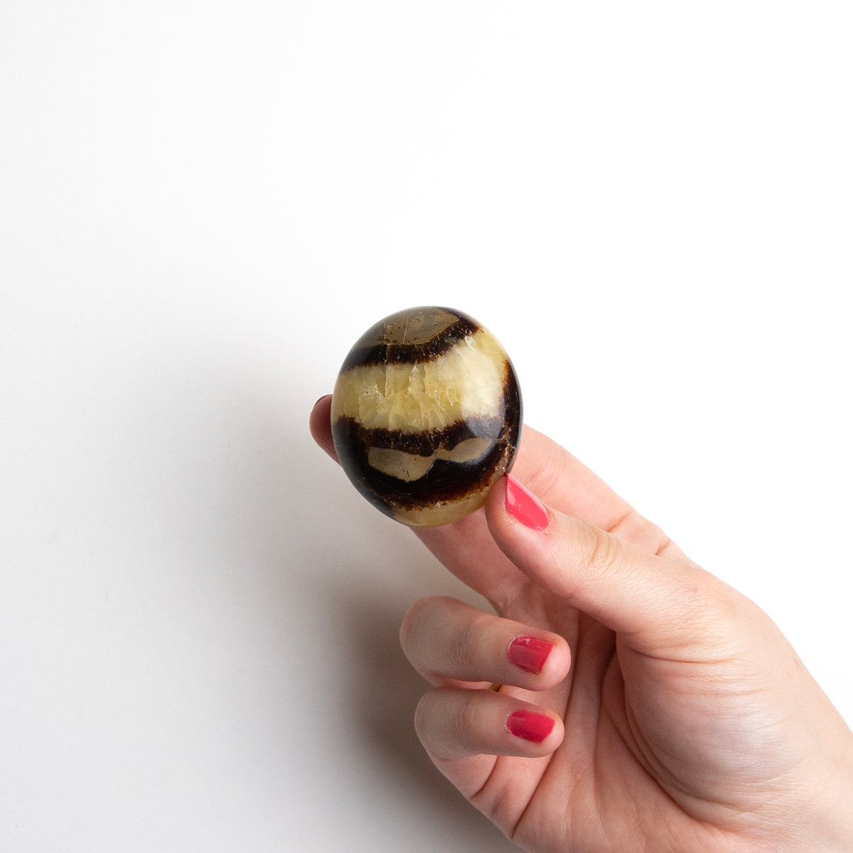 woman holding small Septarian Touchstone by Energy Muse