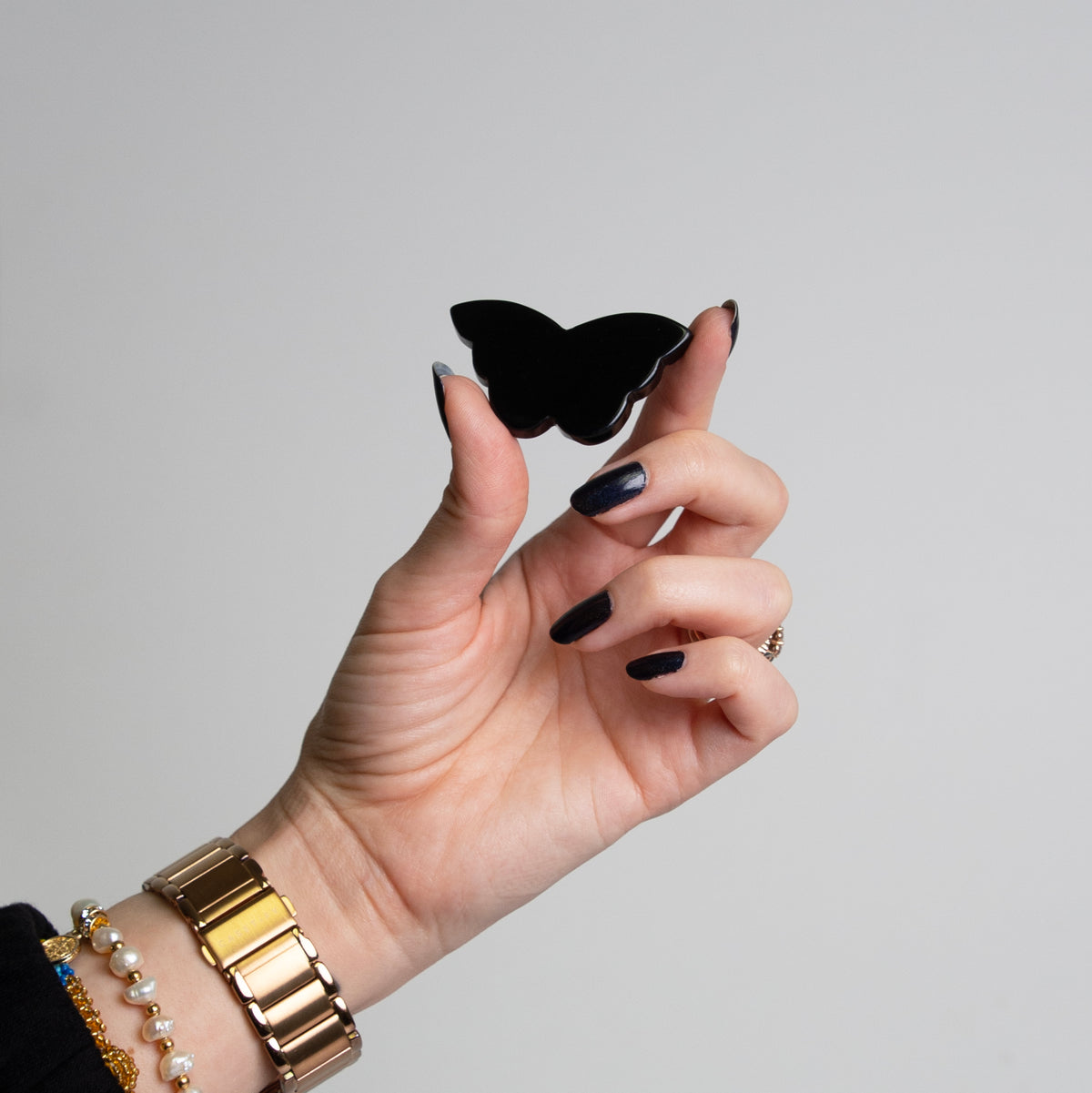 Woman holding Black Onyx butterfly crystal carving by Energy Muse