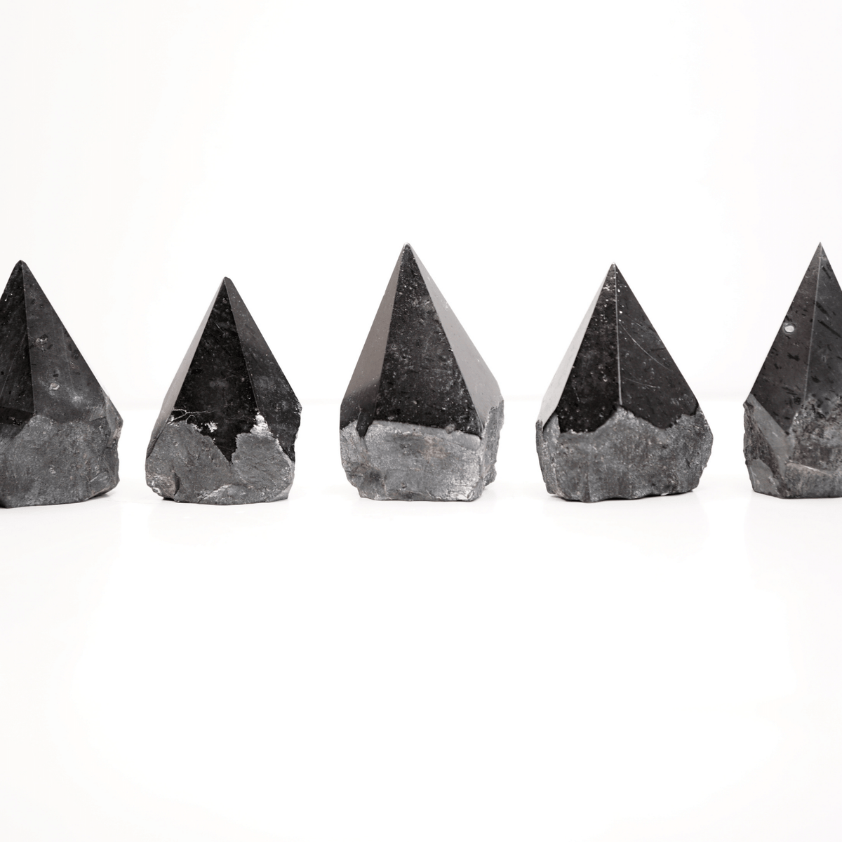 Assortment of 5 half polished Black Tourmaline points by Energy Muse showing the unique variety of shapes, heights, colors, patterns and sizes.