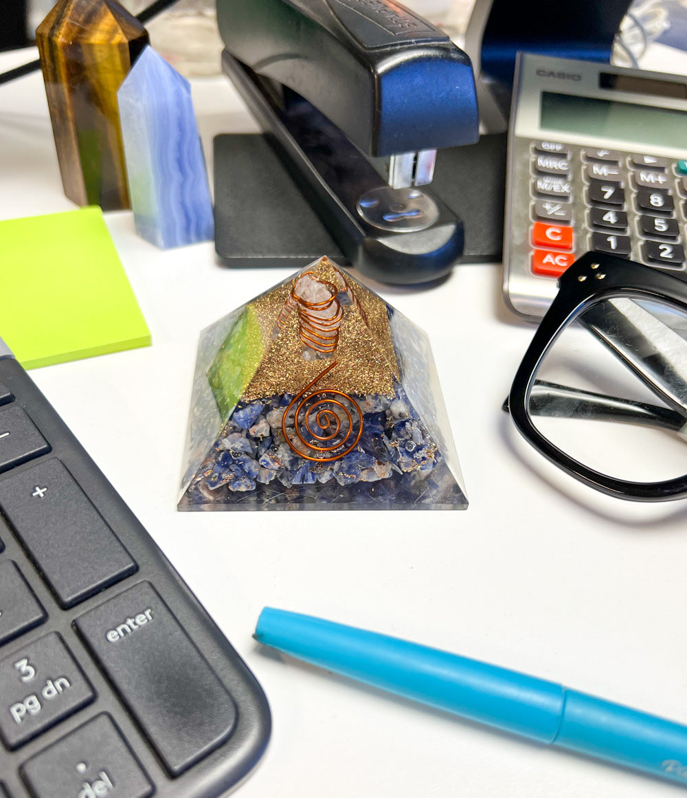 Office desk view of Orgone Pyramid by Energy Muse, with genuine Sodalite. crystal chips, Clear Quartz, and spiraled brass wire.