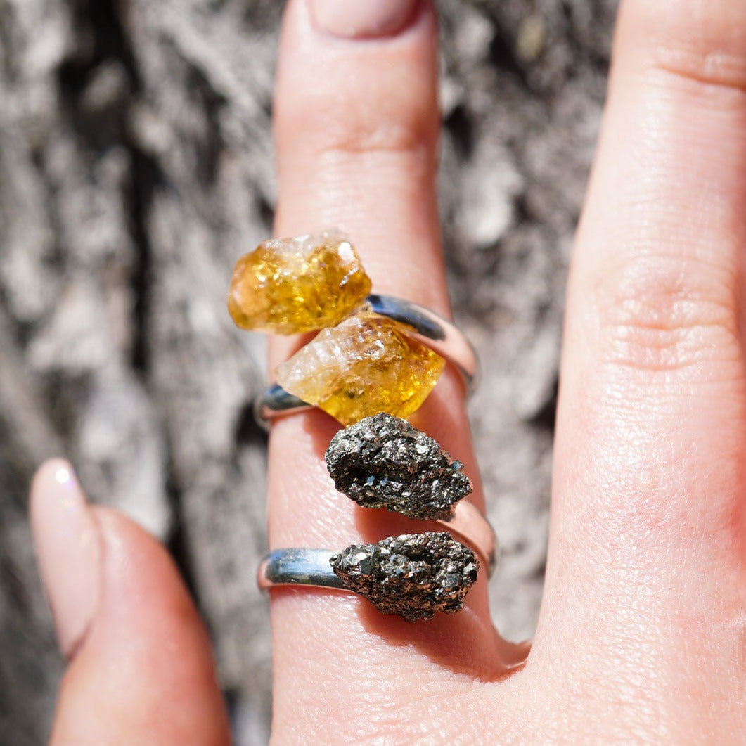 woman's hand wearing genuine gemstone rings by Energy Muse