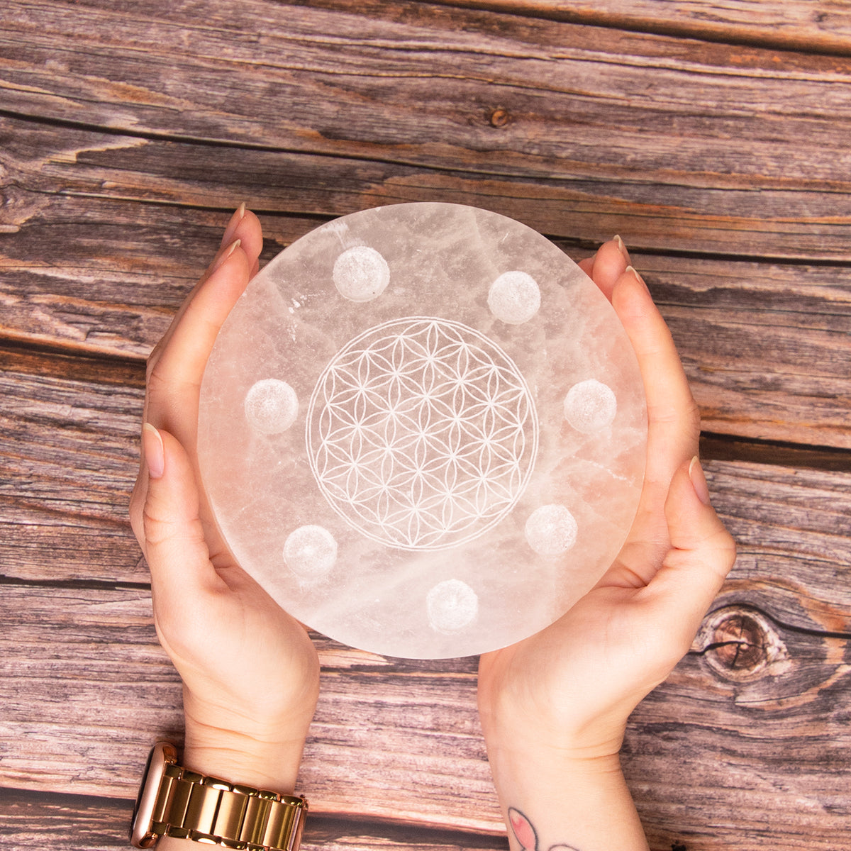 woman holding Lightkeeper Selenite Plate set in both hands by Energy Muse