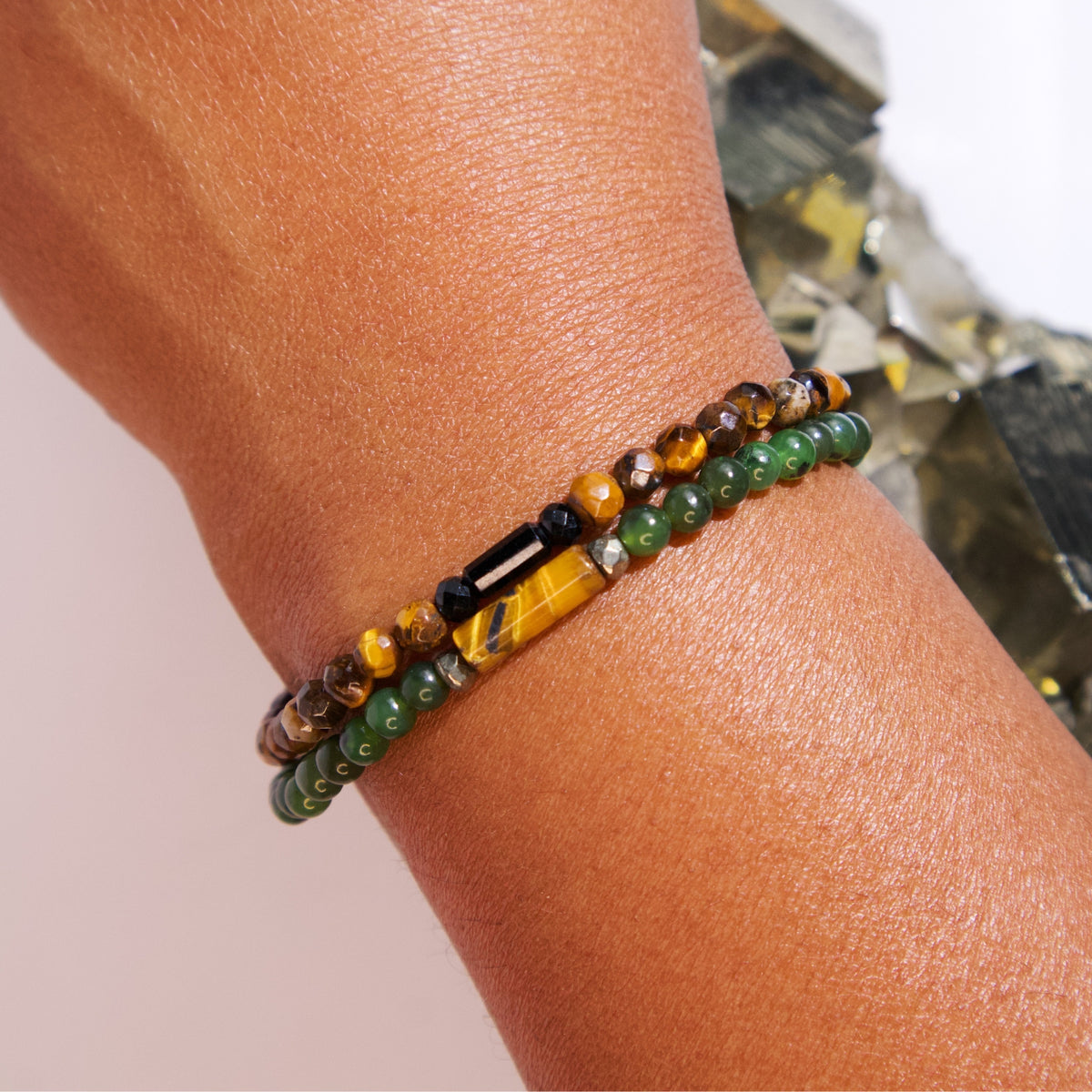 Woman wearing Financial Advisor Bracelet and Think Rich Bracelet by Energy Muse