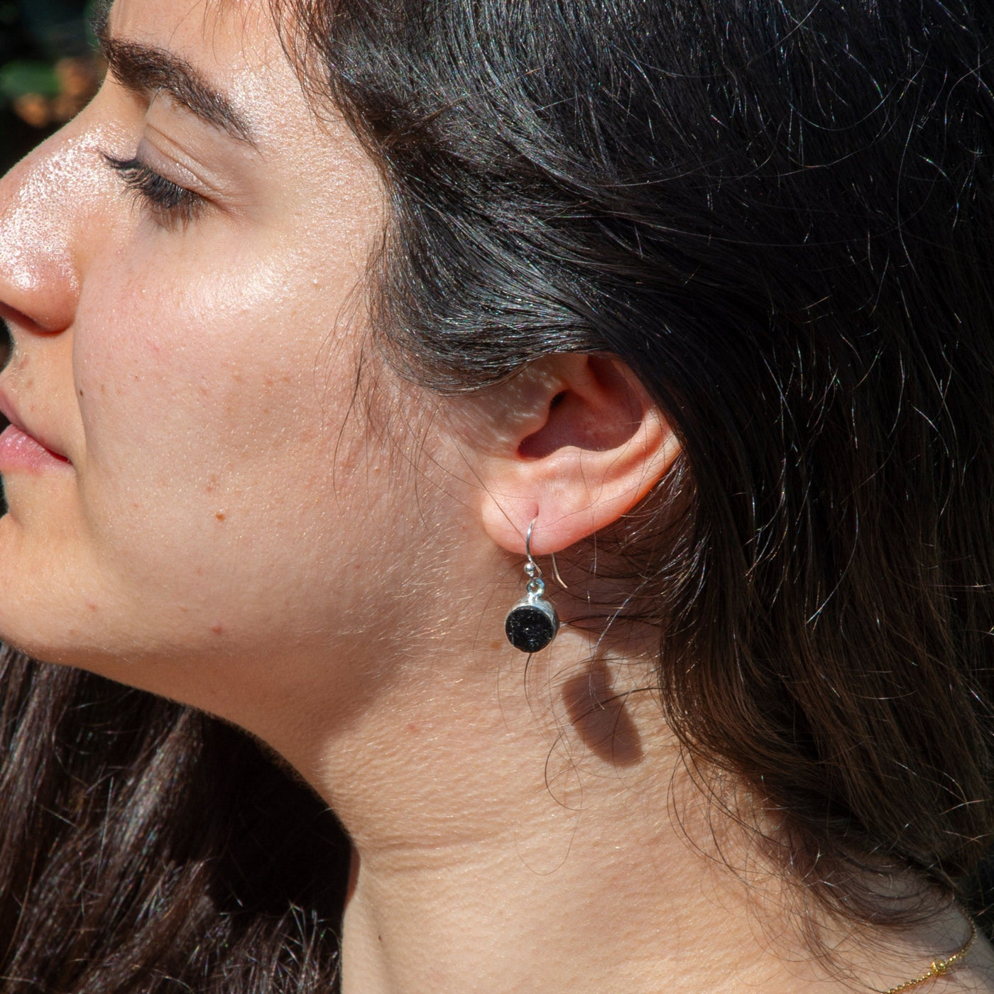 woman wearing genuine Black Tourmaline drop earrings with sterling silver fish hook backs by Energy Muse