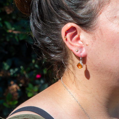 woman wearing genuine Citrine drop earrings with sterling silver fish hook backs by Energy Muse