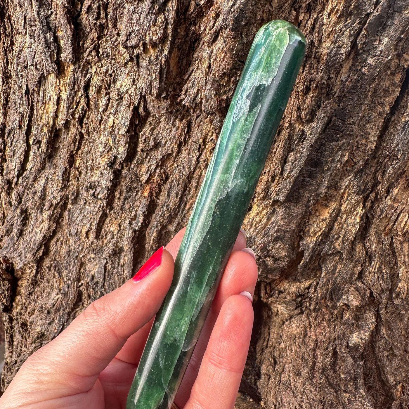woman holding rare translucent a-grade green kyanite wand by Energy Muse