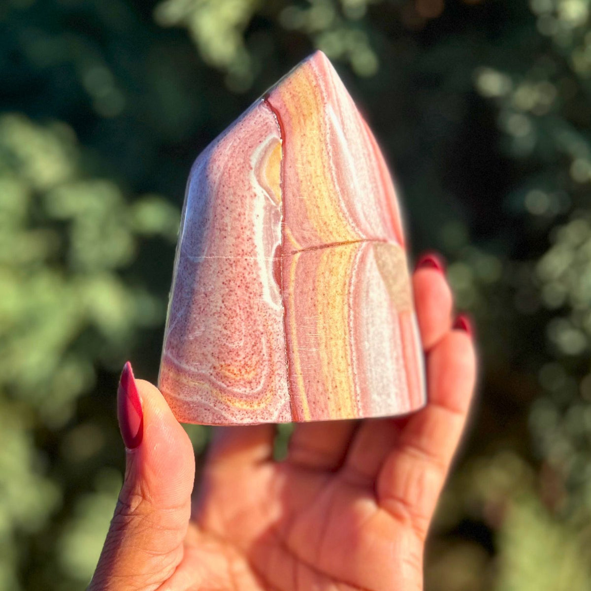 product view of rainbow rhyolite freeform crystal outdoors by Energy Muse