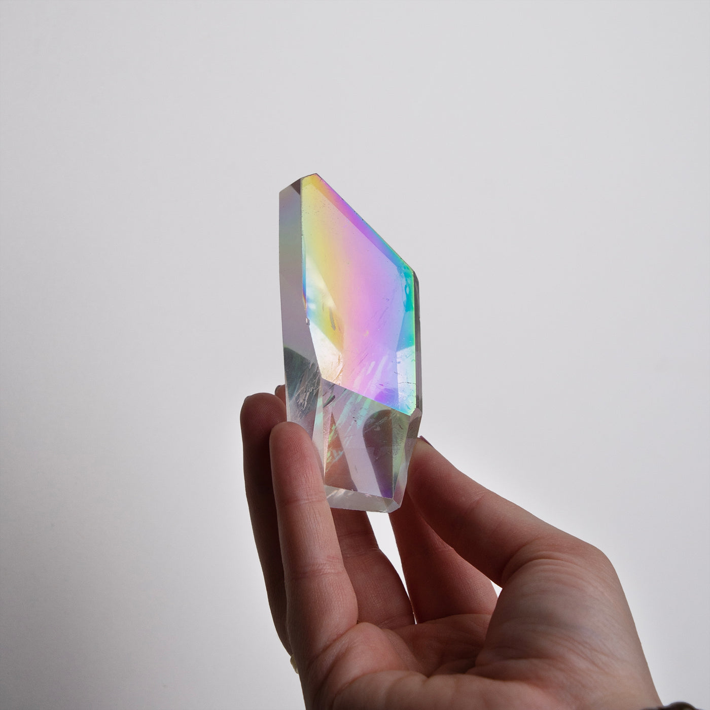 woman holding Opal Aura Quartz Freeeform crystal by Energy Muse