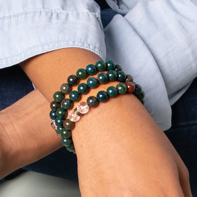 Woman wearing 3 genuine Bloodstone bead stretch elastic crystal bracelets by Energy Muse