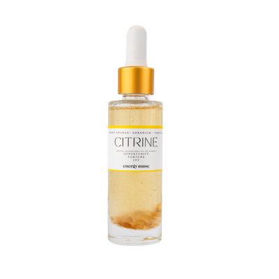 bottle of citrine-infused body oil by Energy Muse