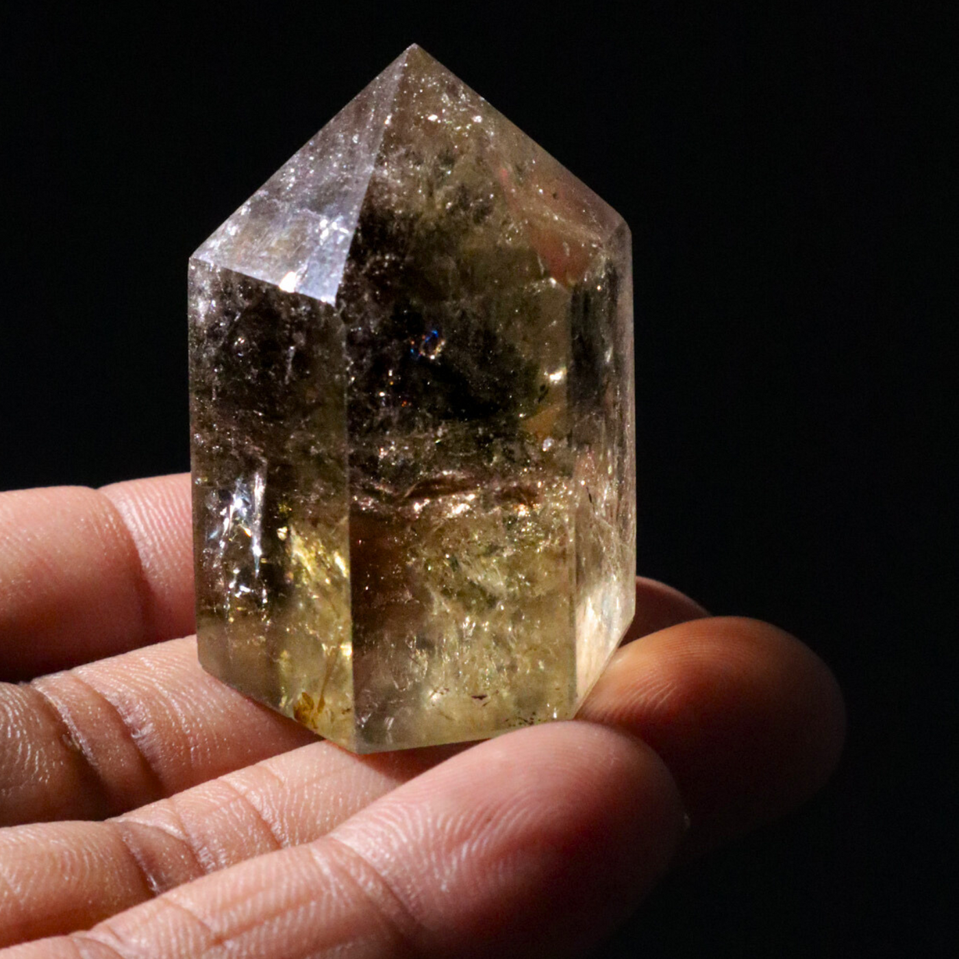 Black woman holding medium sized natural untreated Citrine crystal point by Energy Muse