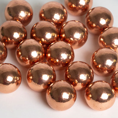 several solid copper spheres by Energy Muse