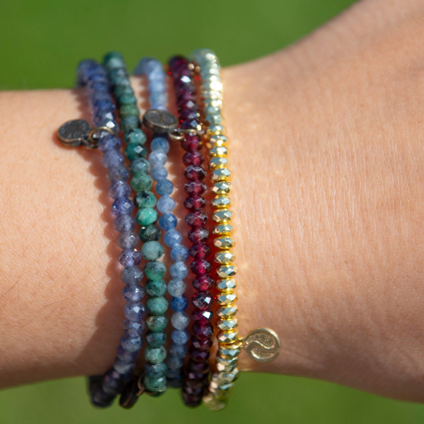 All 5 new mini gemstone bracelets by Energy Muse on woman's wrist 