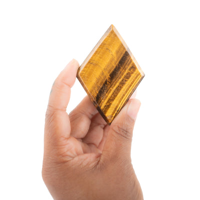 Black woman holding diamond-cut tiger's eye crystal by Energy Muse