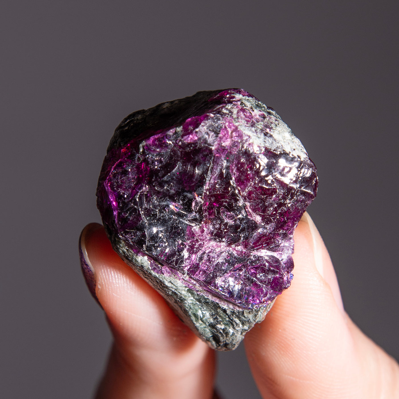 woman holding genuine Garnet raw cluster in mica matrix by Energy Muse