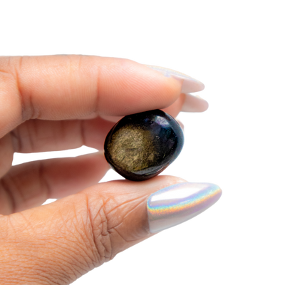 Woman holding golden sheen obsidian tumbled stone - Energy Muse