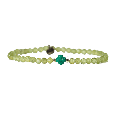 close up view of dainty mini gemstone Perdiot crystal stretch elastic bracelet with four leaf clover-shaped Malachite bead by Energy Muse