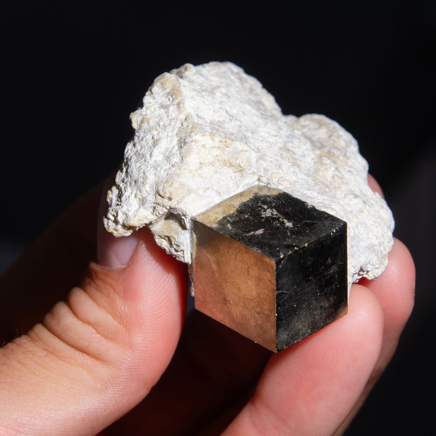 Man holding small natural pyrite cube in matrix from Spain by Energy Muse