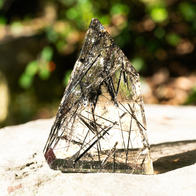 tourmalinated quartz freeform crystal outside in natural sunlight by Energy Muse