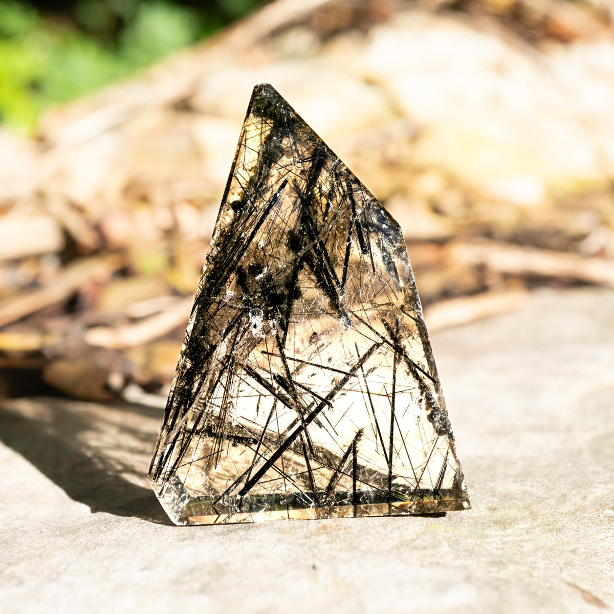 tourmalinated quartz freeform crystal outside in natural sunlight by Energy Muse