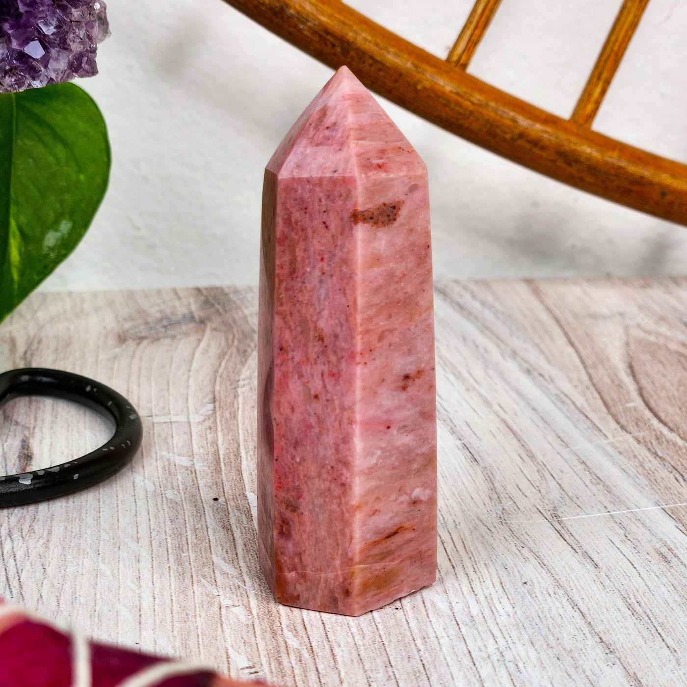 at-home view of genuine Rhodonite Point - Energy Muse