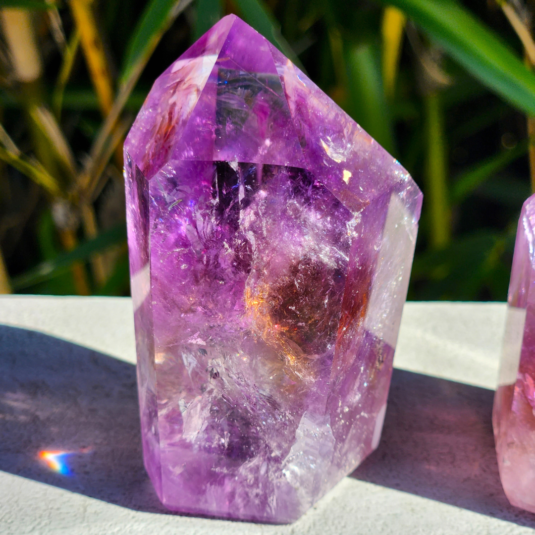 side view of Tucson Find Ametrine Freeform Point photographed outside and highlighting yellow Citrine tinge and extensive rainbows by Energy Muse