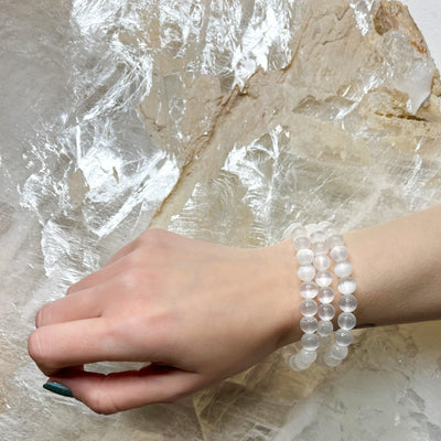 Woman wearing 3 genuine Selenite bracelets by Energy Muse
