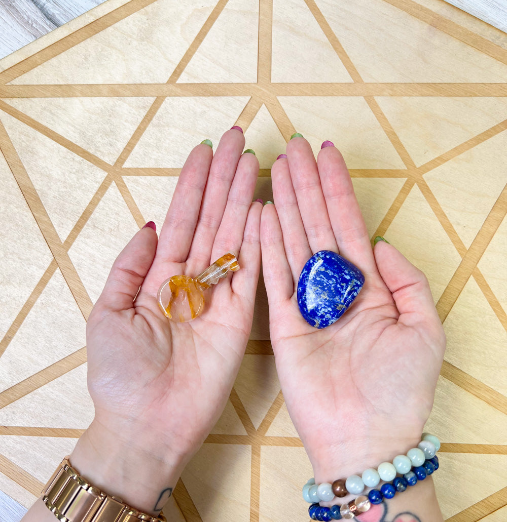 a woman's hands holding a genuine Golden Healer Quartz crystal key and genuine Lapis Lazuli stone by Energy Muse