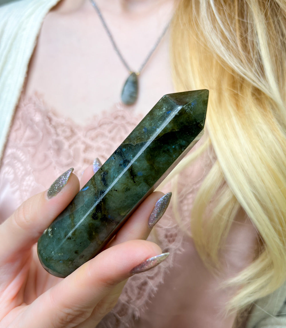 Woman holding genuine Labradorite massage wand by Energy Muse