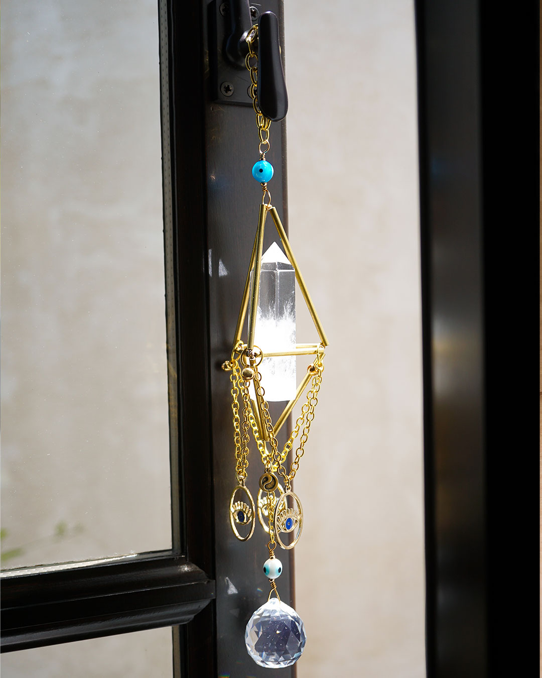 Genuine Clear Quartz point inside metallic gold octahedron chandelier suncatcher with evil eye beads by Energy Muse