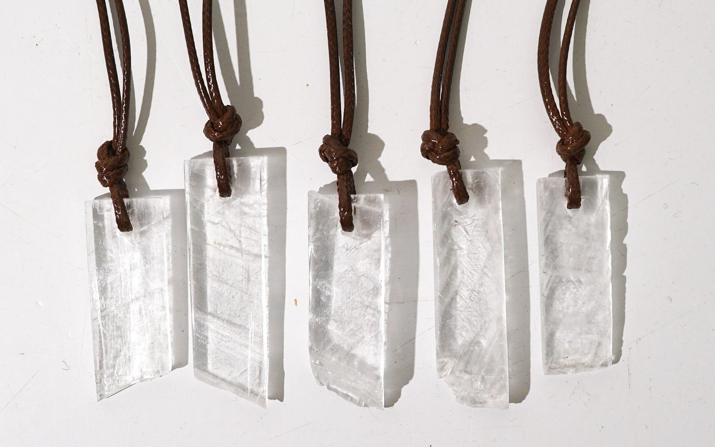 group of 5 genuine natural Selenite pendant necklaces by Energy Muse that show variety in sizes 