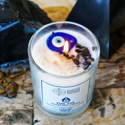 at-home view of Evil Eye candle with Black Obsidian, Clear Quartz and painted glass evil eye pendant by Energy Muse