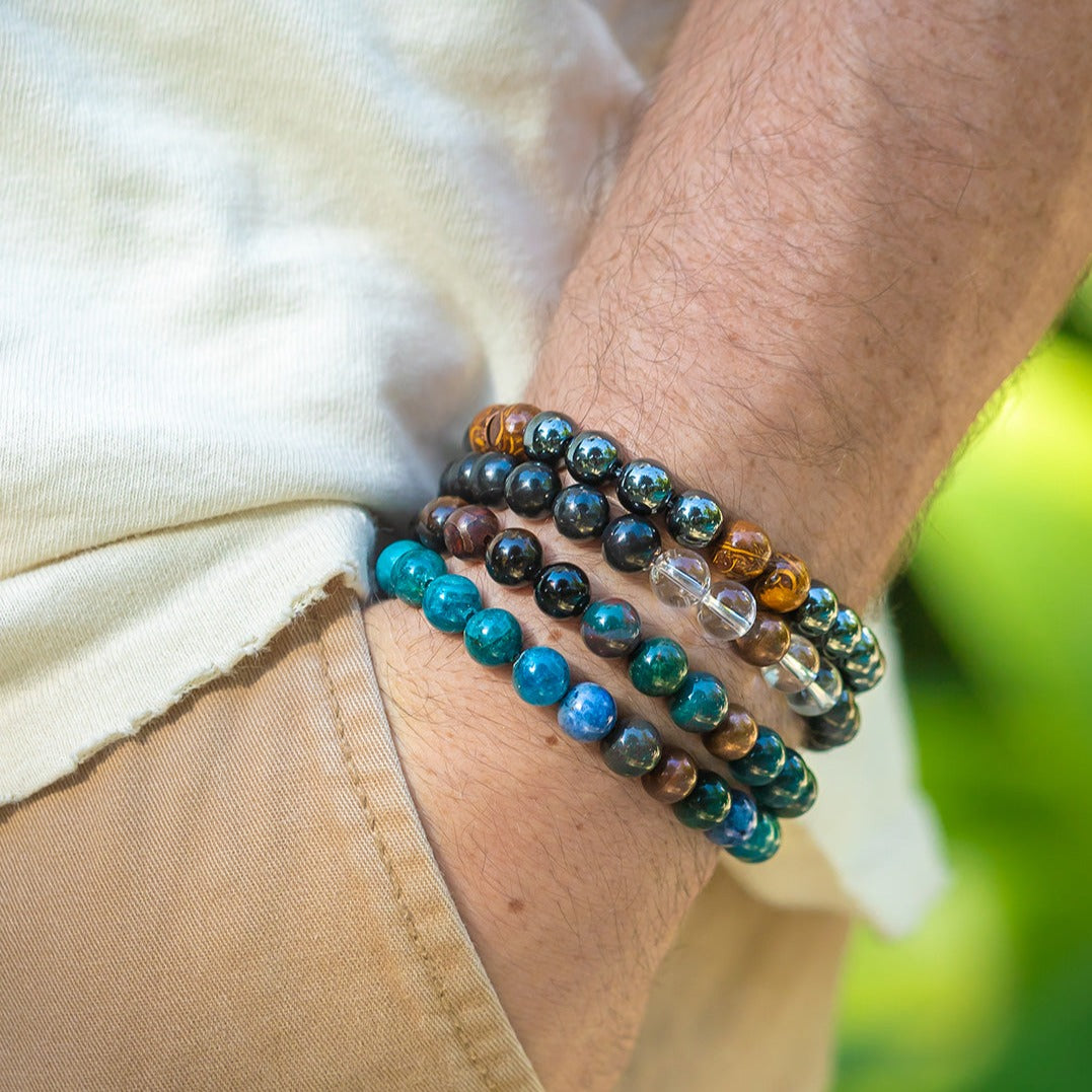Close up of white man's wrist wearing Health Crystal Bracelet, Grounding Bracelet and Protection Bracelet by Energy Muse