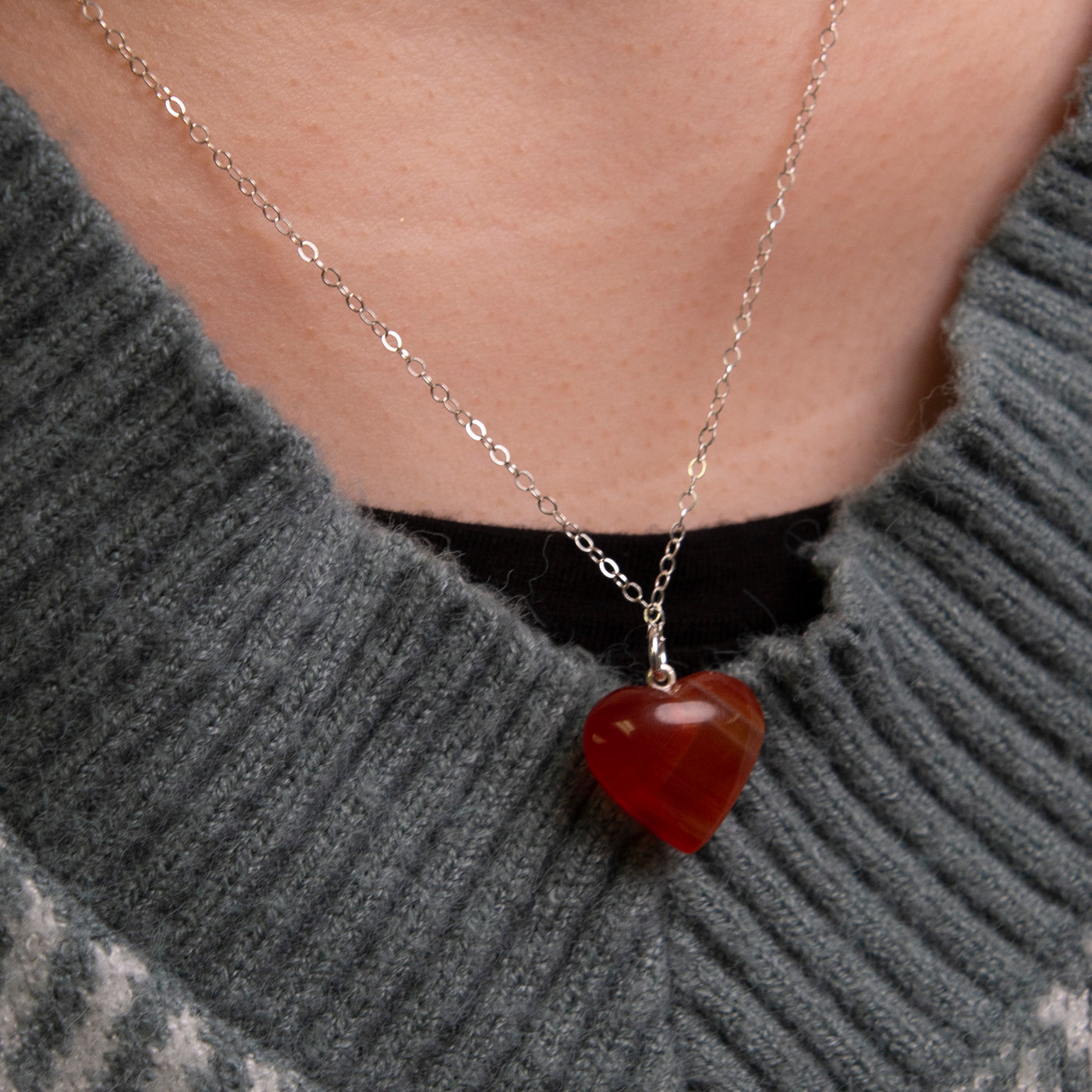 close up of woman wearing genuine Carnelian heart necklace by Energy Muse