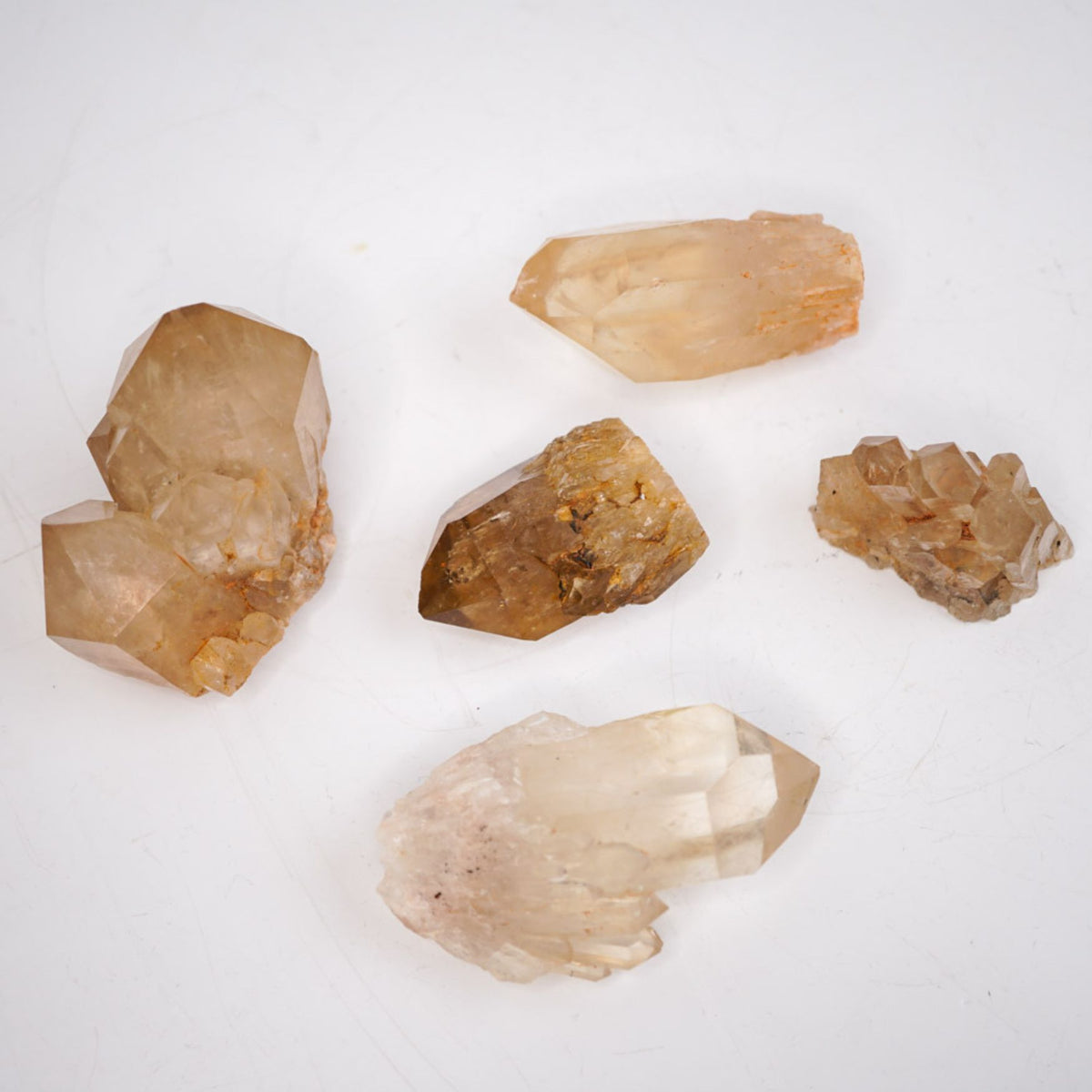 Assortment of 5 Kundalini Citrine by Energy Muse displaying the variety of shapes, sizes, patterns and colors.