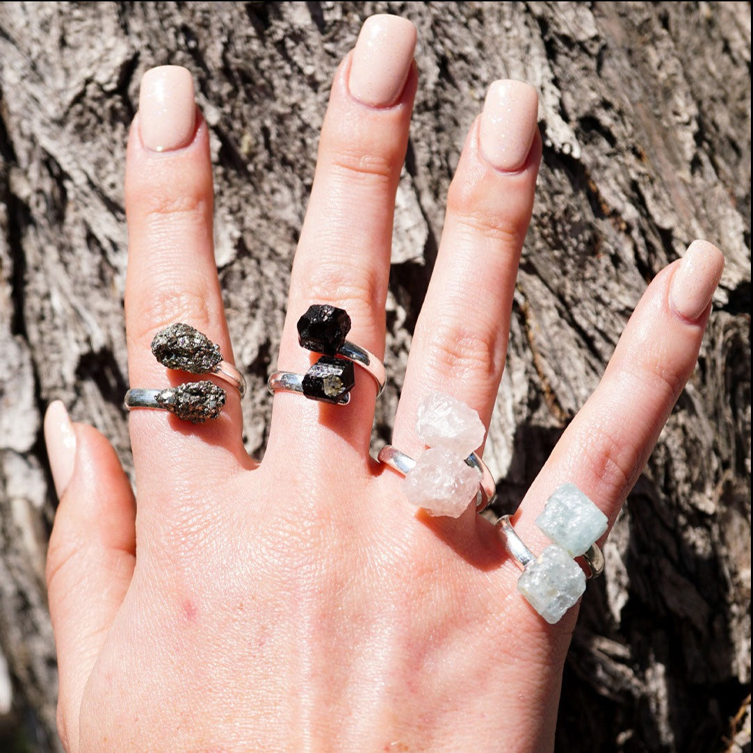 woman's hand wearing genuine gemstone rings by Energy Muse