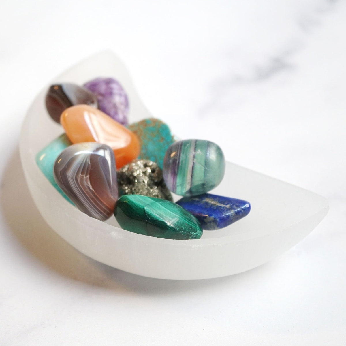 small Selenite Satin Spar half moon crescent shaped bowl by Energy Muse full of banded genuine crystals 