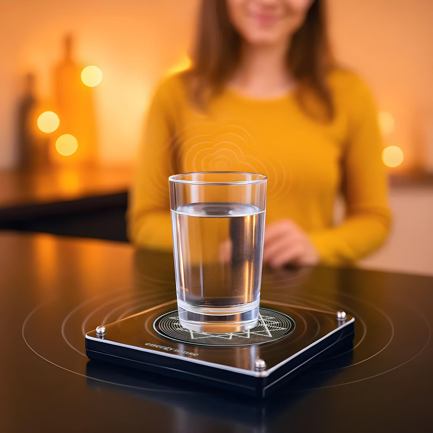 A glass of water resting on a frequency generator
